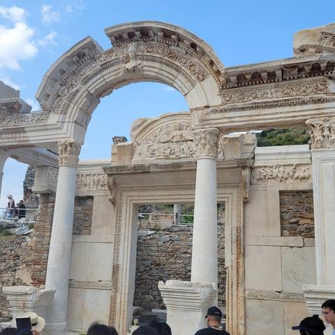       Ruins of a temple with ornate columns and architecture.
  