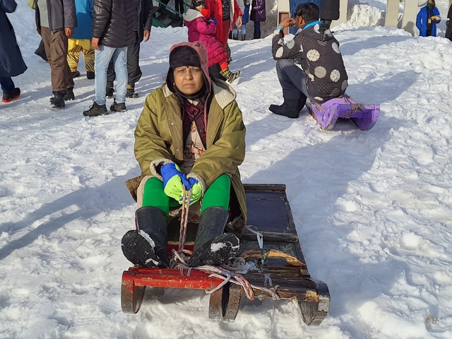 Person sledding in the snow.