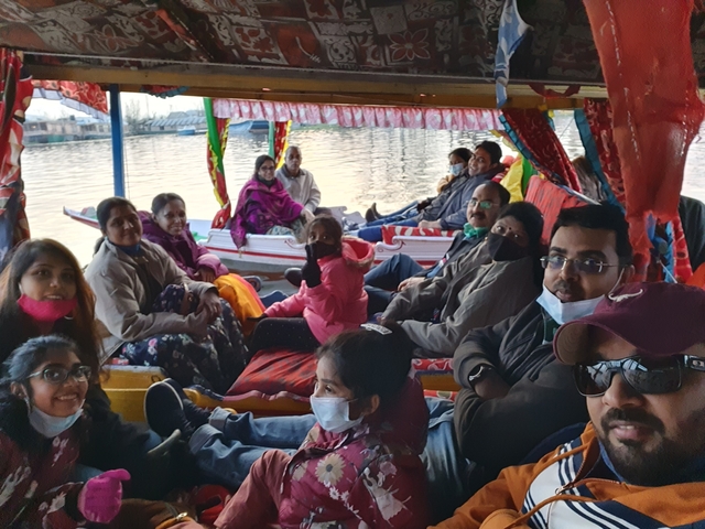 Group of people on a boat in a scenic lake.