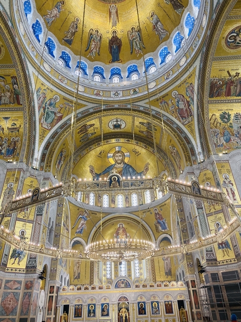       Interior of a church with gold and iconography.
  