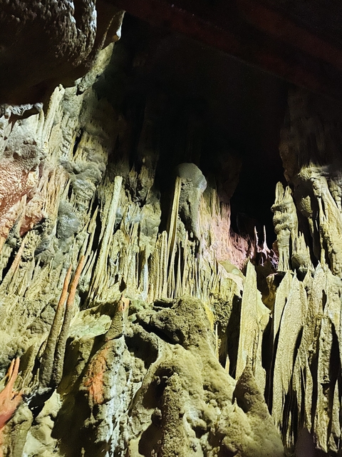 Inside of a cave with numerous stalagmites.