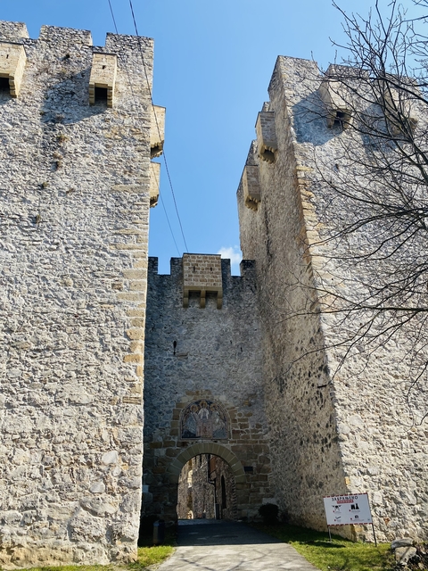       Stone fortress wall with blue sky in the background.
  