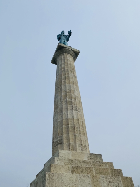 Tall stone column against a clear sky.