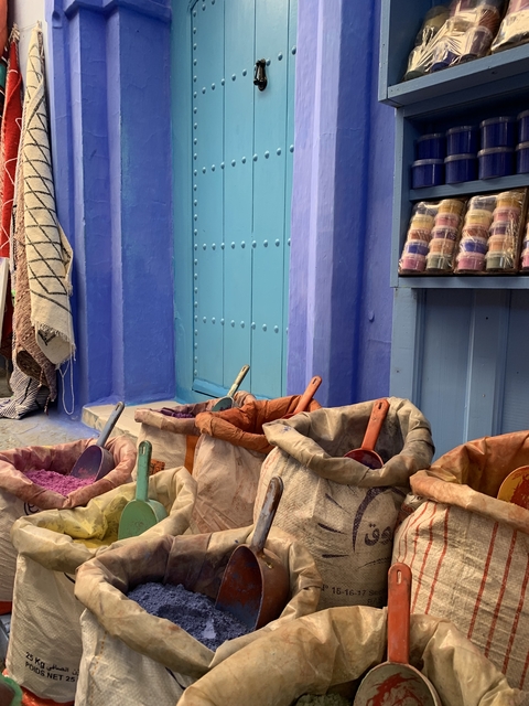       Colorful baskets with pigments in an alley.
  