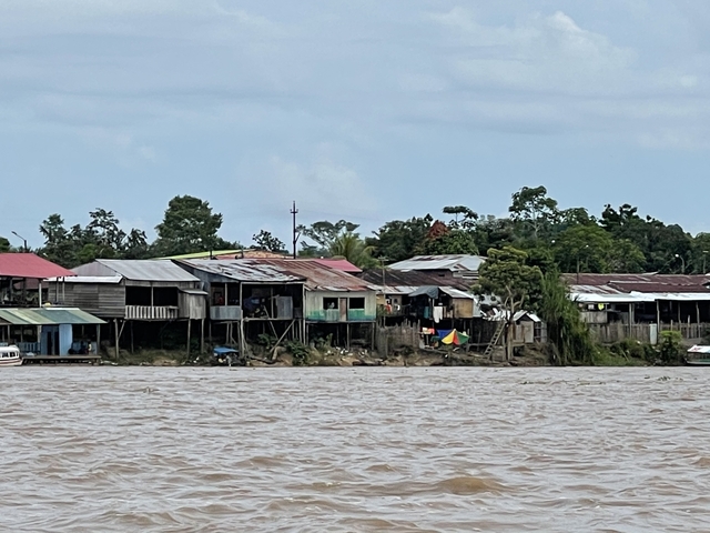 Wooden houses along a riverbank.