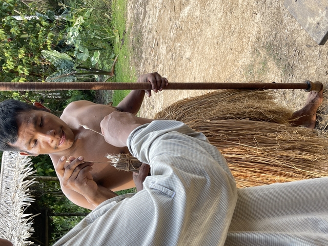 Man in traditional clothing performing a ritual.