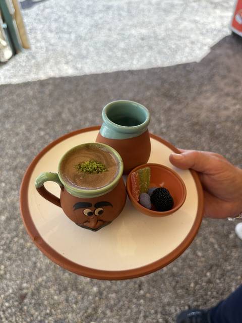       Cups and treats on a tray with artistic presentation.
  