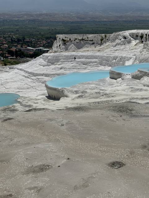       Terraces with blue water pools.
  