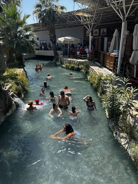 People swimming in a natural thermal pool.