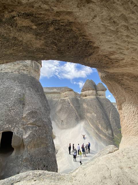 Group of people exploring rocky formations.