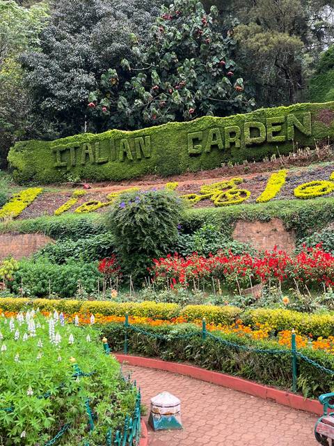 Colorful flower bed with the words 'Italian Garden' shaped by plants.