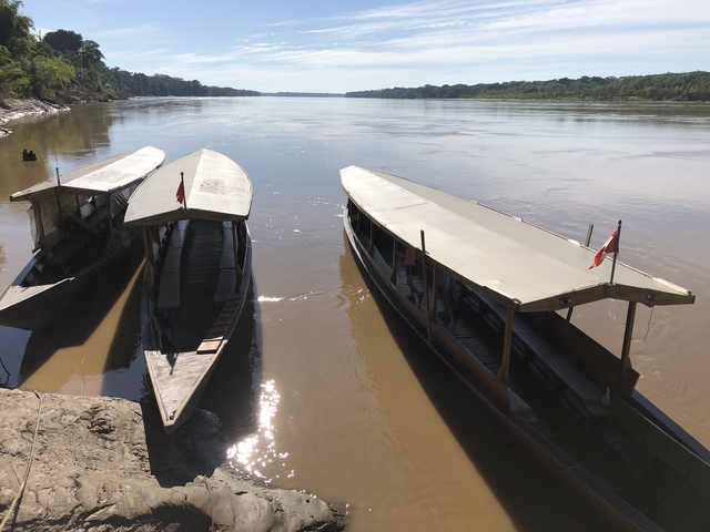 Two boats docked on a river shore
