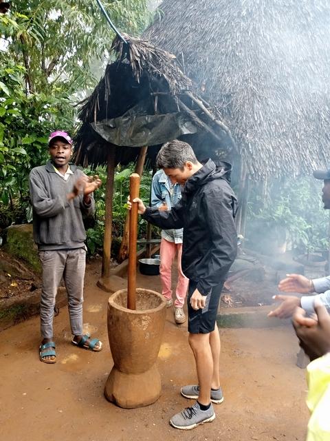 Cultural activity with two men demonstrating traditional techniques.