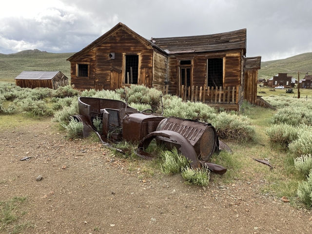       Old wooden buildings in a ghost town setting.
  