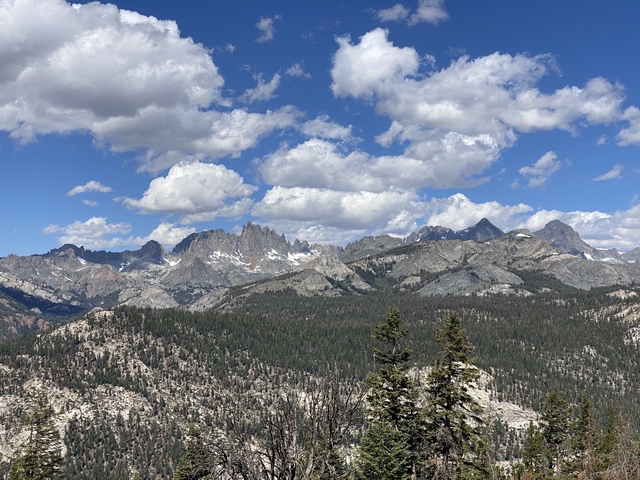       Mountain range with snow-capped peaks under blue skies.
  