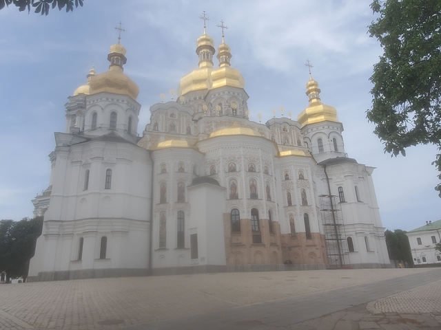 Blurry image of a white building with golden domes.