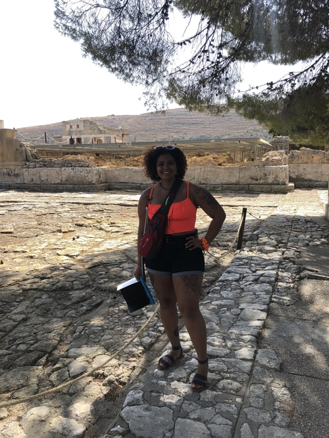       Person standing on ancient ruins.
  