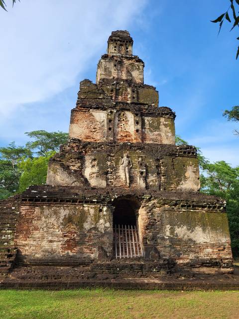      An ancient temple-like structure with detailed brickwork.
  