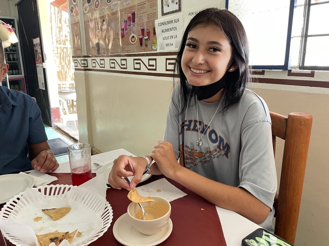       Smiling person dining at a restaurant
  