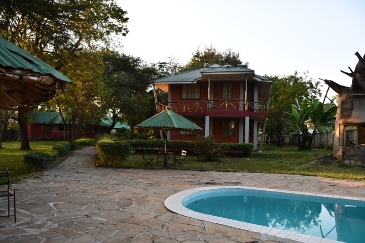       Accommodation in a tranquil garden setting with a swimming pool.
  