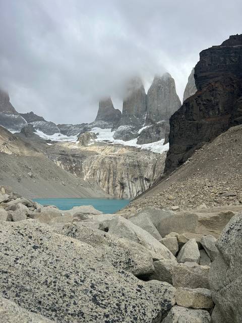 Rock towers rising above a turquoise lake.