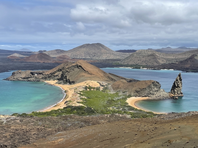       Aerial view of a volcanic peninsula with beaches.
  