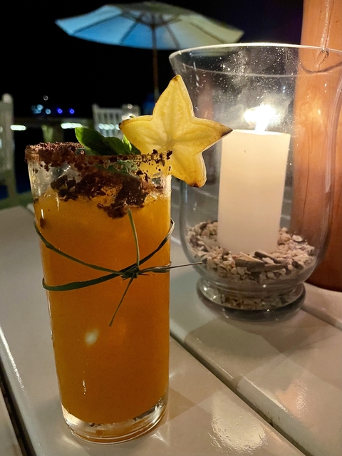       Close-up of a cocktail glass with decorative elements.
  