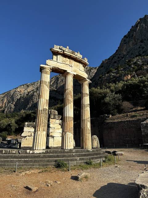       Ancient Greek temple ruins against a clear blue sky.
  