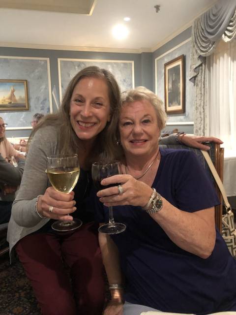 Two women enjoying drinks indoors.