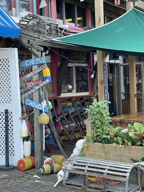 Outdoor cafe with colorful signs and chairs.