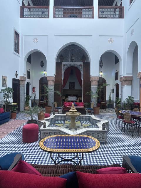 Interiors of a traditional Moroccan courtyard with a fountain.