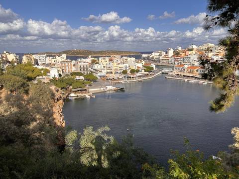 Sea view with boats and coastal town.