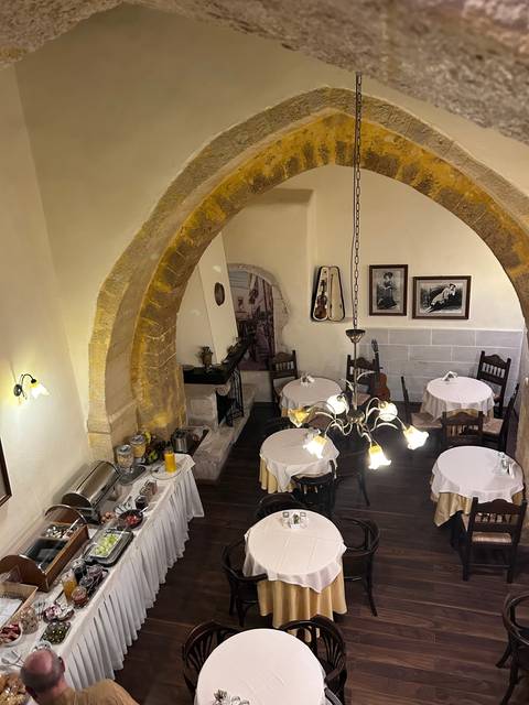 Interior of a restaurant with tables set and vintage decor.