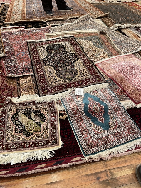 Collection of colorful and intricate rugs.
