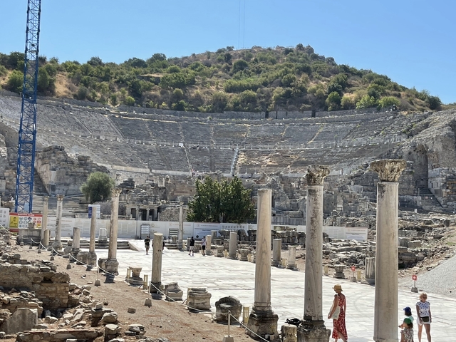       Ancient amphitheater ruins with a hill in the background.
  