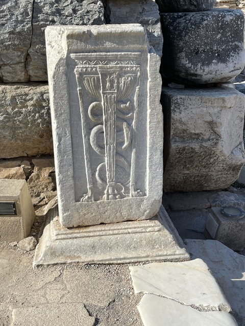       Carved stone with a relief sculpture.
  