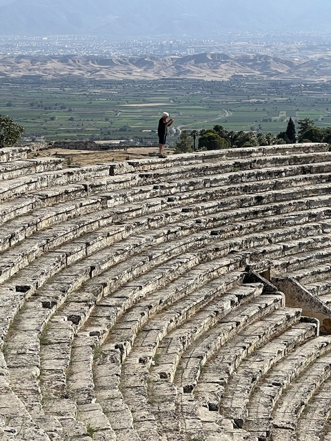       Rows of stone seating in an ancient amphitheater.
  