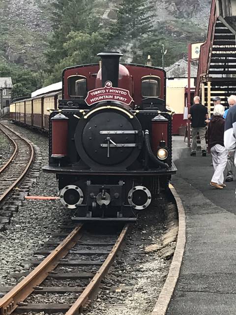       A vintage steam locomotive on railway tracks.
  