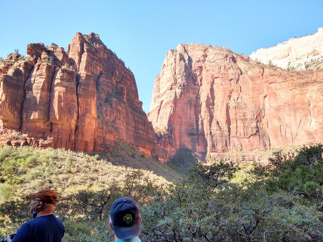 The magnificent red rock formations of Zion National Park with a blue sky.