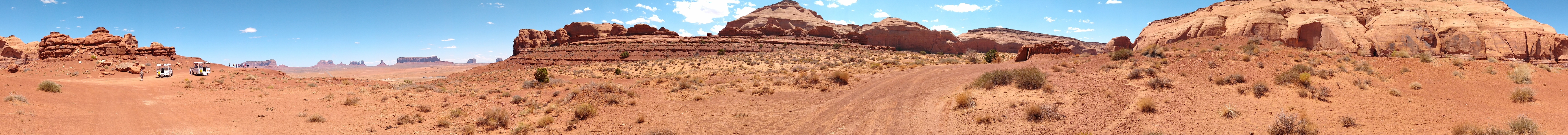 The rugged red terrain and mesas of Monument Valley under the clear sky.