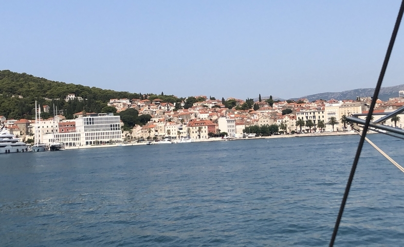       City coastline with buildings viewed from a boat.
  