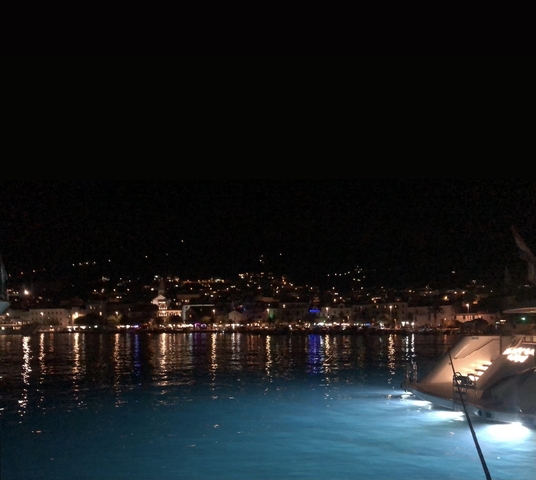       City view at night with lights reflecting on water.
  