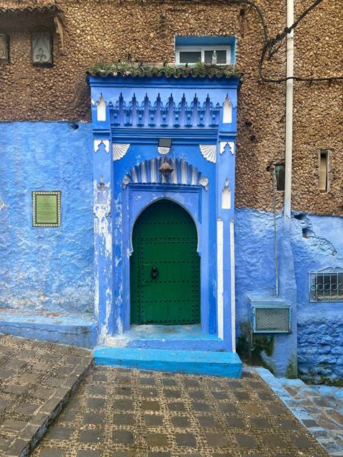       Traditional blue doorway with ornate decorations.
  