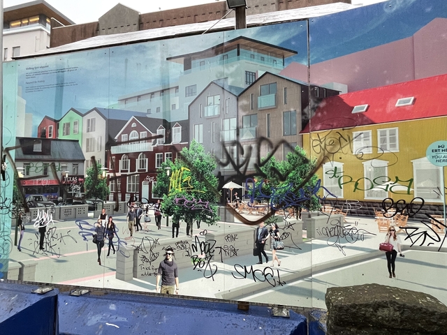       Urban mural with graffiti overlay.
  