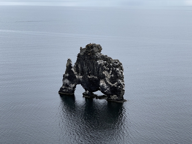       Rocky sea stack in the ocean.
  