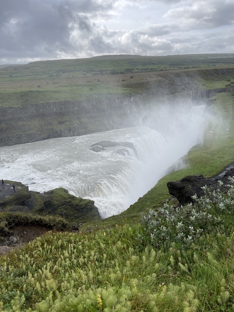 Powerful waterfall with mist rising from the base.