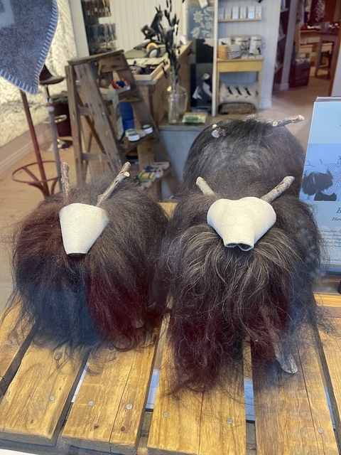       Window display with two woollen horns and fuzzy textures.
  