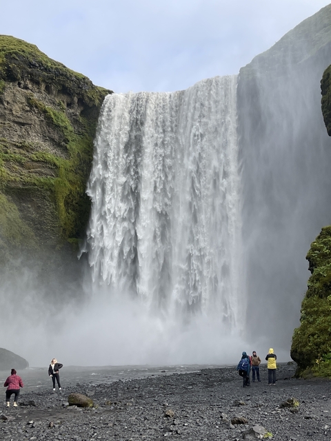       Close-up of gushing waterfall over rocks.
  