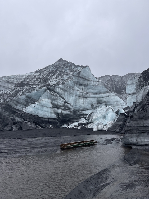 Imposing glacier with layers of ice and rock.