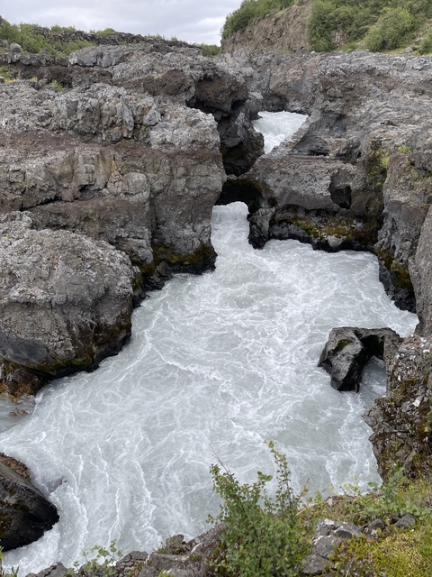       Rugged coastline with intense water flow over rocks.
  